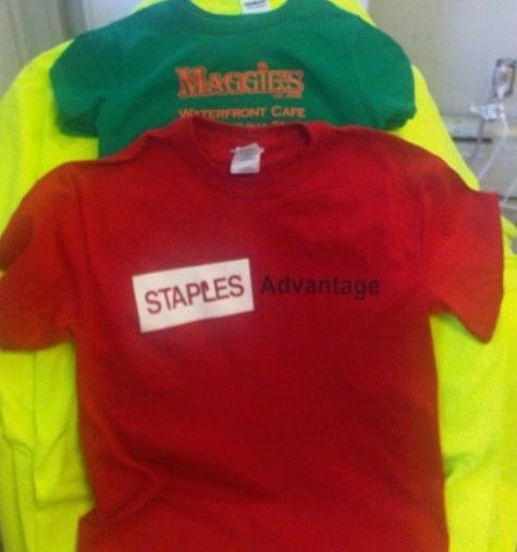 Red, green and yellow tees feature Staples Advantage branding. The photograph brings the different garment colors together in one view.