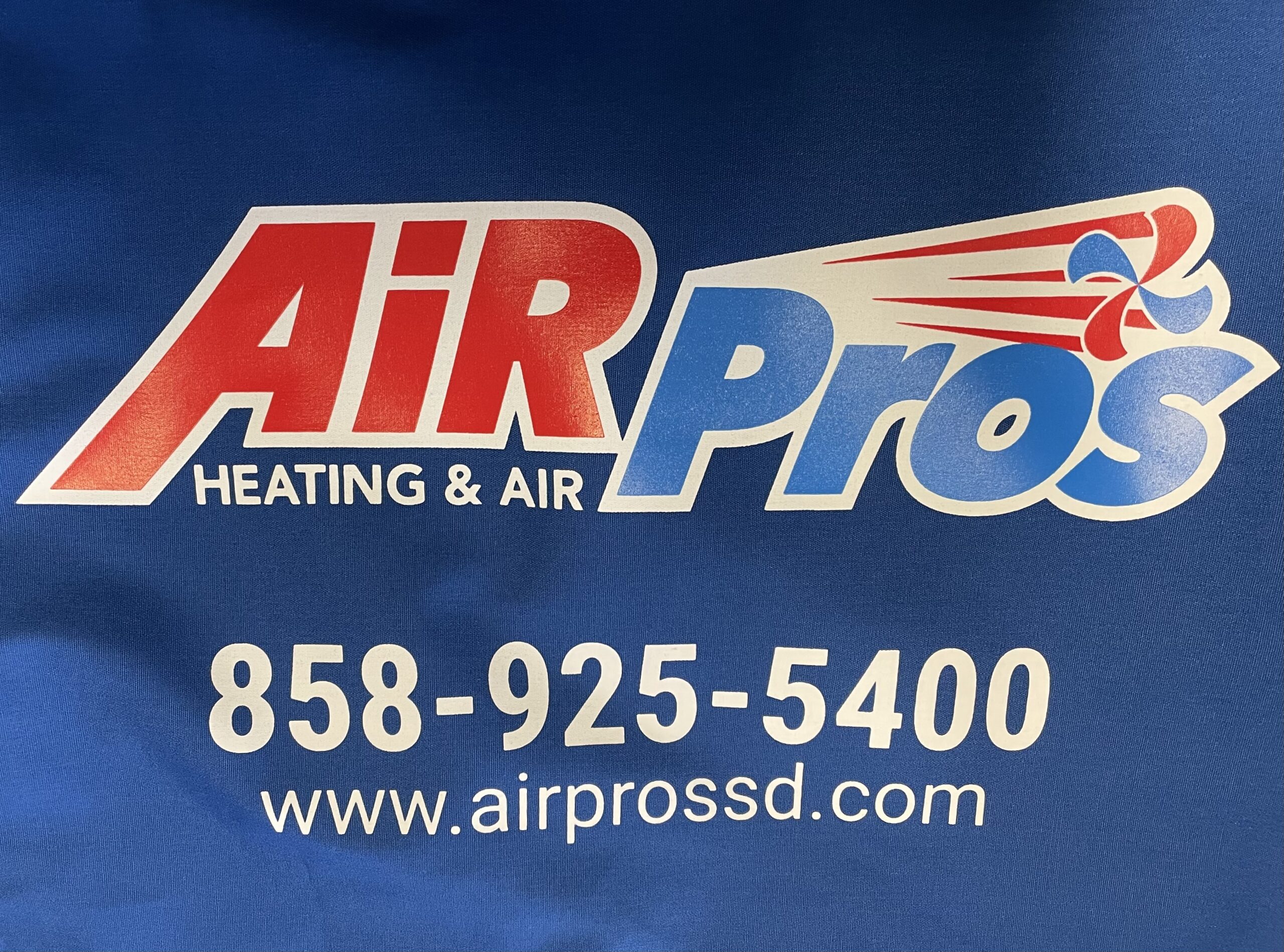 Red, white and blue Air Pros lettering fills the frame, with a flag motif and the company contact details below.